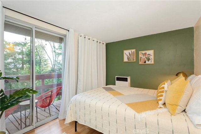 579 E Victoria Ct, Lake Arrowhead, CA 92352 - bedroom with heating unit, wood finished floors, and access to exterior