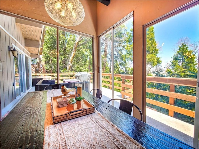 579 E Victoria Ct, Lake Arrowhead, CA 92352 - sunroom featuring an inviting chandelier, a healthy amount of sunlight, and outdoor dining area