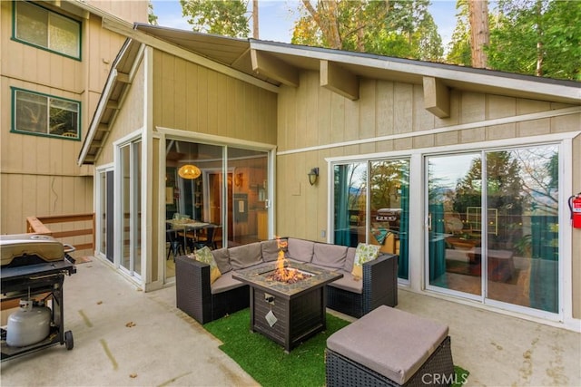 579 E Victoria Ct, Lake Arrowhead, CA 92352 - rear view of house with an outdoor living space with a fire pit and a patio