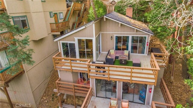 579 E Victoria Ct, Lake Arrowhead, CA 92352 - rear view of house featuring an outdoor living space and a chimney