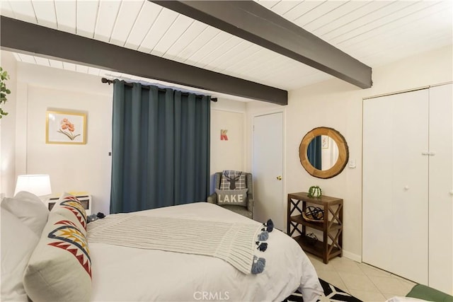 579 E Victoria Ct, Lake Arrowhead, CA 92352 - bedroom featuring a closet, beam ceiling, baseboards, and light tile patterned floors