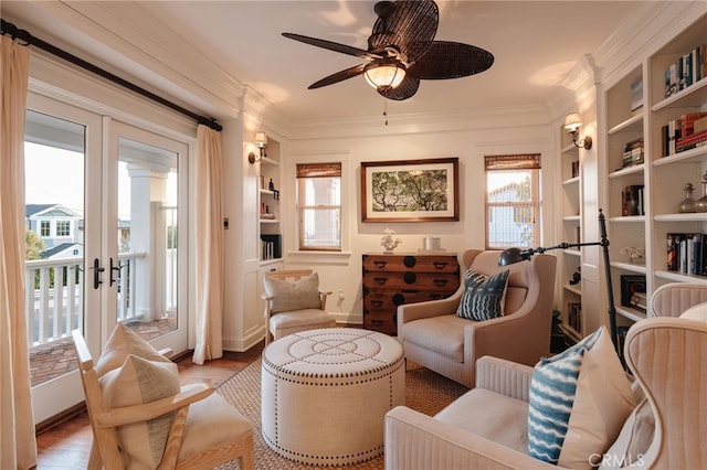 living area with french doors, ornamental molding, built in features, ceiling fan, and light hardwood / wood-style floors