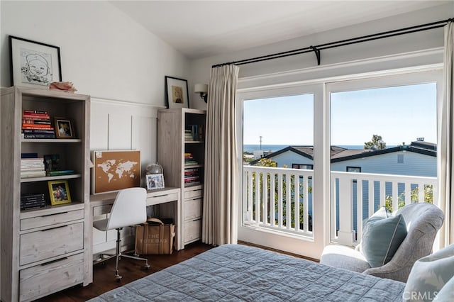 bedroom with multiple windows, dark wood-type flooring, and access to exterior