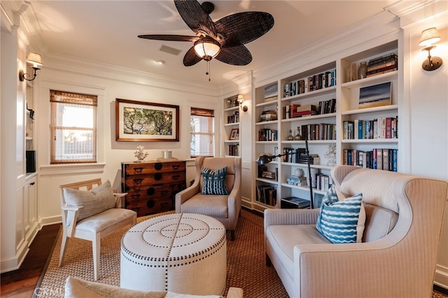 sitting room featuring crown molding, dark wood-type flooring, ceiling fan, and built in shelves