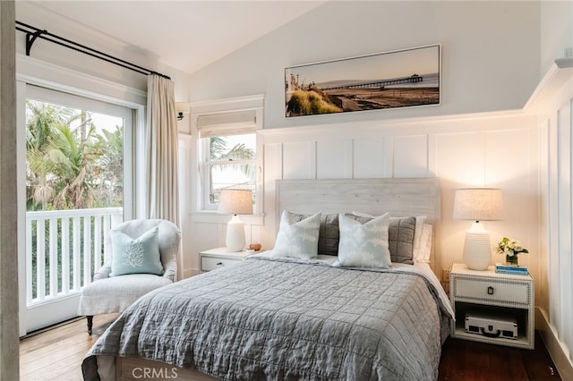 bedroom featuring lofted ceiling and hardwood / wood-style floors