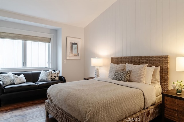 bedroom featuring hardwood / wood-style flooring and lofted ceiling