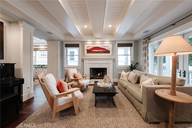 living room with beamed ceiling, dark hardwood / wood-style floors, and a fireplace