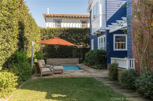 view of pool featuring a patio area and a lawn