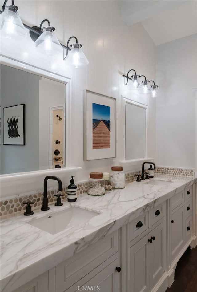 bathroom featuring vanity and vaulted ceiling with beams