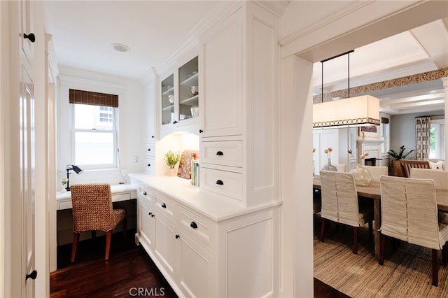 interior space featuring dark wood-type flooring and crown molding