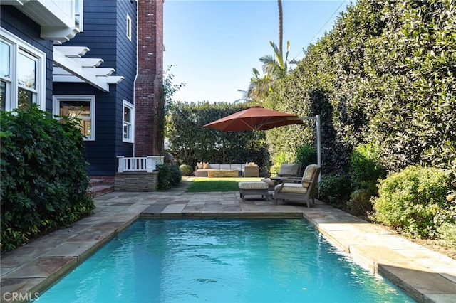 view of swimming pool with outdoor lounge area and a patio area