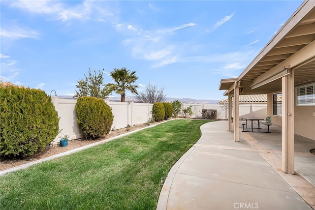 view of yard featuring a mountain view and a patio area