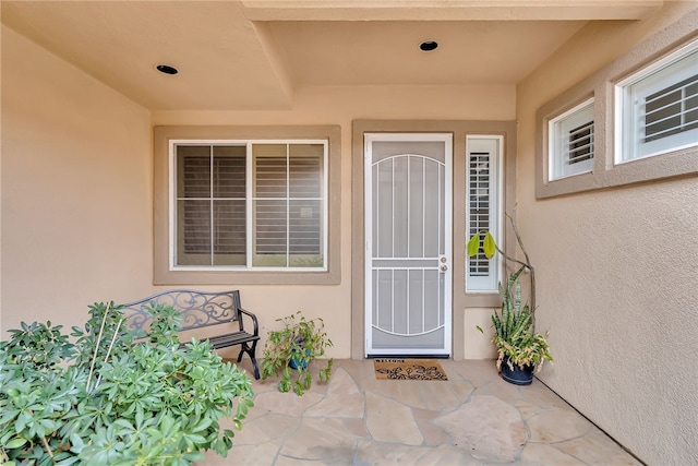 view of exterior entry featuring a patio