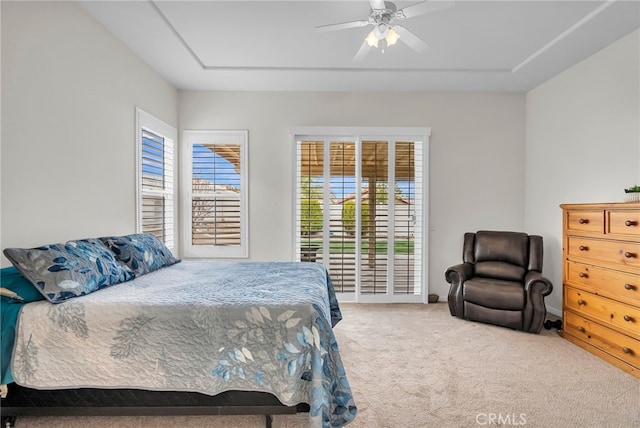 carpeted bedroom featuring multiple windows and ceiling fan