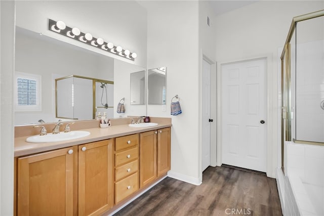 bathroom featuring vanity, hardwood / wood-style floors, and walk in shower