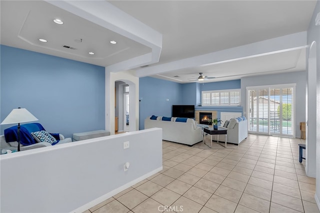 living room with ceiling fan and light tile patterned floors