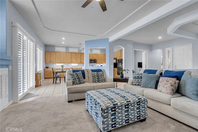 living room featuring ceiling fan and light tile patterned flooring