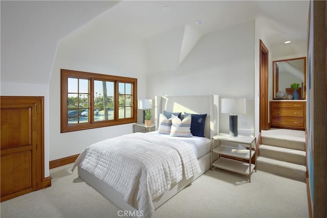 carpeted bedroom featuring vaulted ceiling