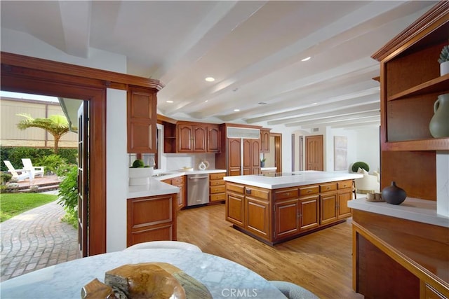 kitchen featuring beam ceiling, a center island, dishwasher, and light wood-type flooring