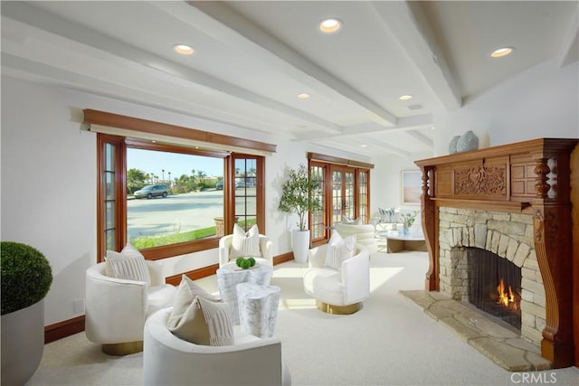 interior space featuring beamed ceiling, a fireplace, and light carpet