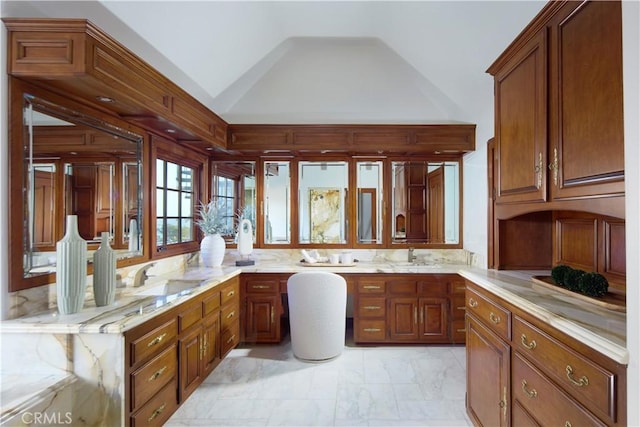 bathroom with vaulted ceiling, sink, and decorative backsplash