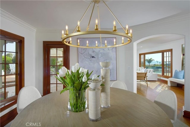 dining space with crown molding and hardwood / wood-style flooring