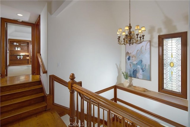 stairway with a chandelier