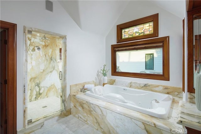 bathroom with separate shower and tub and vaulted ceiling