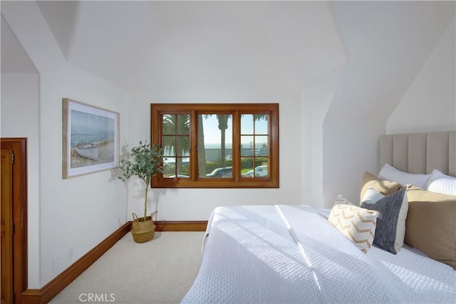 carpeted bedroom with vaulted ceiling