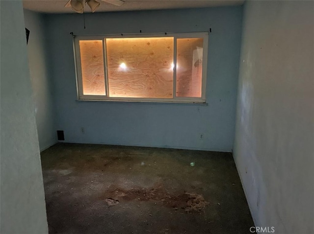 unfurnished room with ceiling fan and a wealth of natural light