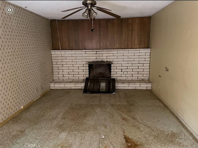 unfurnished living room with ceiling fan