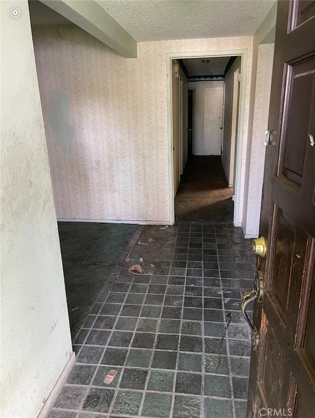 hallway featuring a textured ceiling