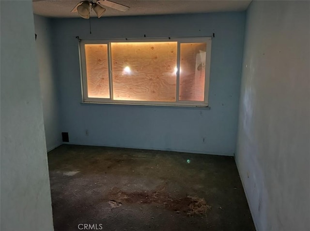 spare room with concrete flooring, plenty of natural light, and ceiling fan