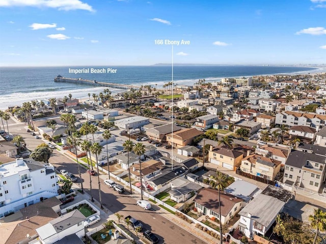 drone / aerial view featuring a water view and a view of the beach