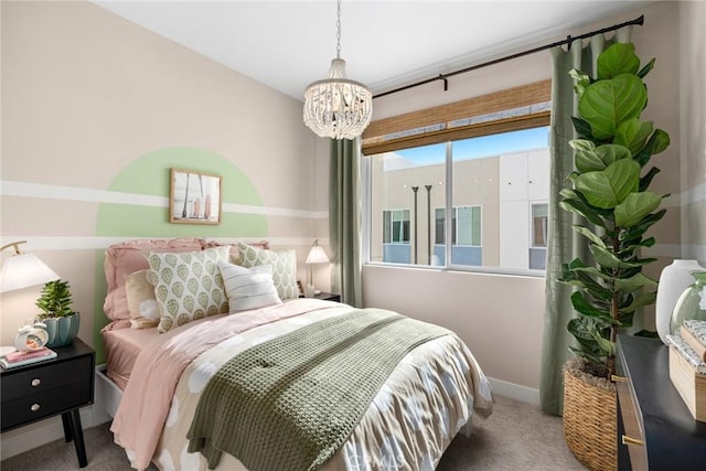 bedroom featuring an inviting chandelier and carpet floors