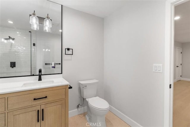 bathroom featuring vanity, toilet, and walk in shower