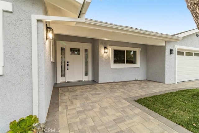 doorway to property featuring a garage