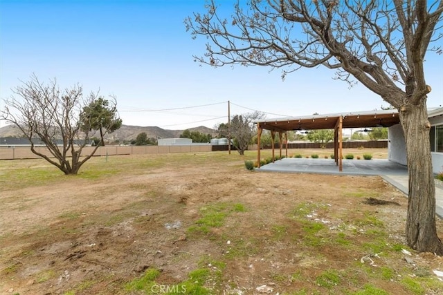 view of yard featuring a mountain view and a patio area