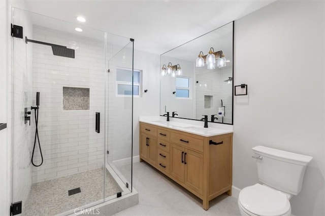 bathroom featuring vanity, toilet, and an enclosed shower