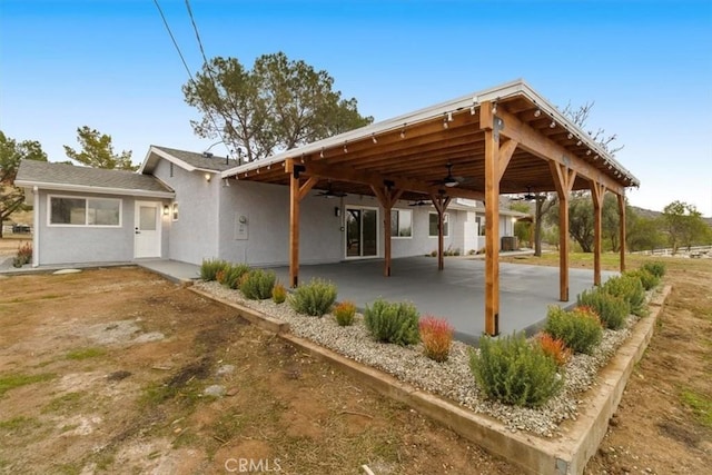 rear view of property with a patio area and ceiling fan