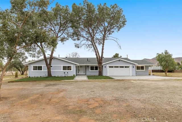 ranch-style home with a garage and a front lawn