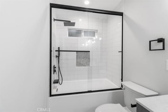 full bathroom with toilet, vanity, and bath / shower combo with glass door