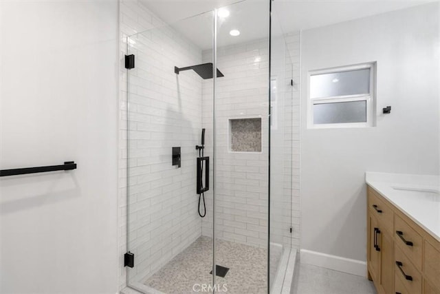 bathroom featuring walk in shower and vanity