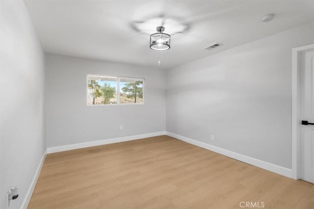 spare room with light hardwood / wood-style flooring