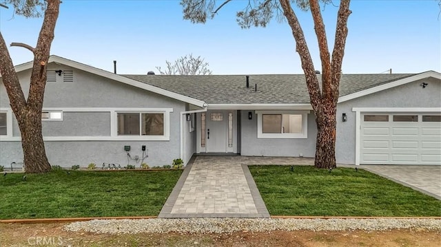 ranch-style house with a garage and a front lawn