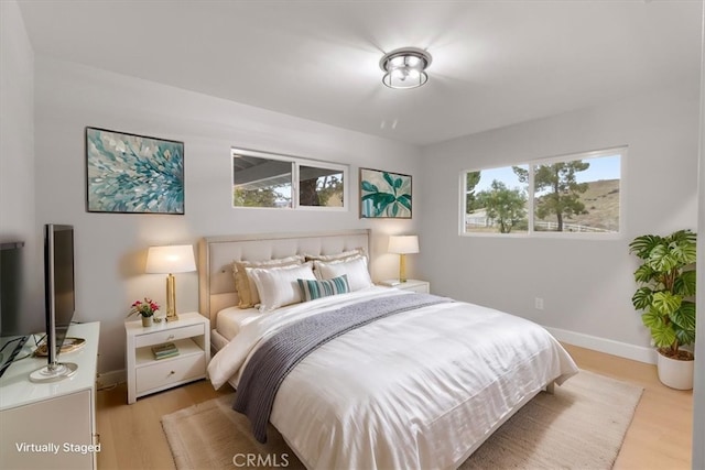 bedroom with light wood-type flooring