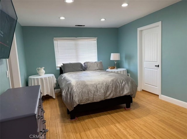 bedroom featuring recessed lighting, light wood-style floors, and baseboards