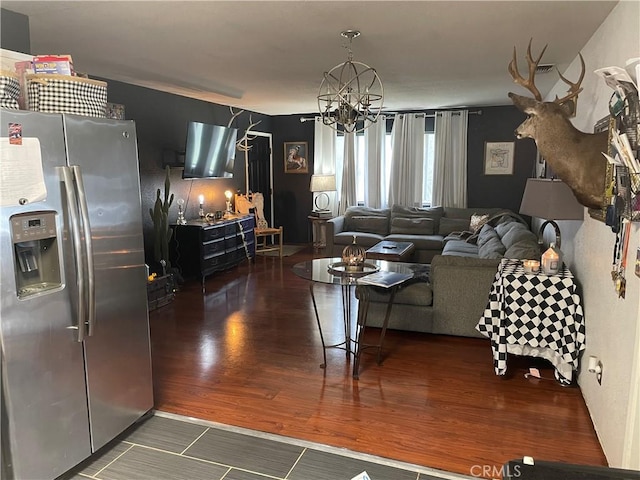 living room with dark hardwood / wood-style floors and a chandelier