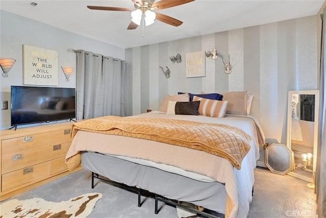 bedroom with ceiling fan and concrete flooring