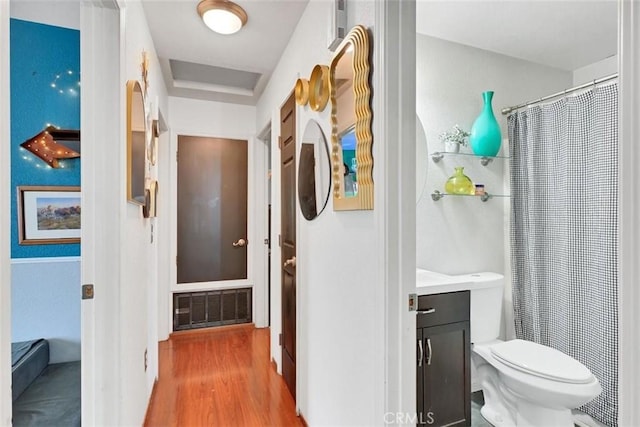 bathroom featuring toilet, hardwood / wood-style flooring, and vanity